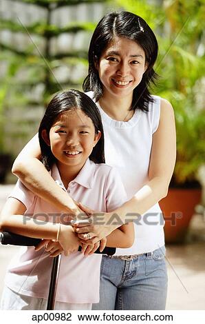 Mother and daughter, looking at camera, portrait View Large Photo Image Stock Image - Mother and daughter, looking at camera, portrait. Fotosearch
