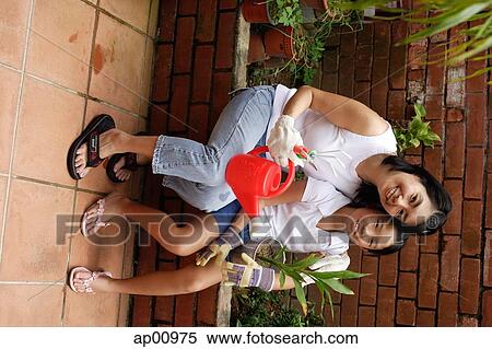 Mother and daughter, sitting, looking at camera View Large Photo Image Stock Photography - Mother and daughter, sitting, looking at camera. Fotosearch