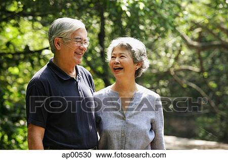 Senior couple standing side by side, smiling View Large Photo Image Stock Image - Senior couple standing side by side, smiling. Fotosearch