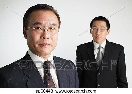 Stock Image - Two Businessmen looking at camera. Fotosearch