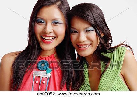 Two women looking at camera, smiling, portrait View Large Photo Image Stock Image - Two women looking at camera, smiling, portrait. Fotosearch
