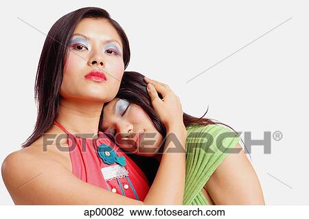 Two women, one looking at camera, the other resting with eyes closed View Large Photo Image Stock Image - Two women, one looking at camera, the other resting with eyes closed. Fotosearch