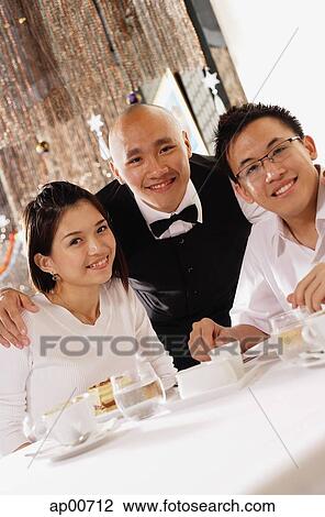 Waiter and customers at restaurant, looking at camera, portrait View Large Photo Image Stock Image - Waiter and customers at restaurant, looking at camera, portrait. Fotosearch