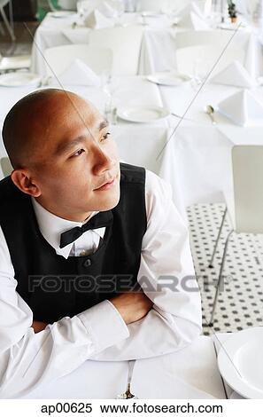 Waiter sitting at table, arms crossed View Large Photo Image Stock Photography - Waiter sitting at table, arms crossed. Fotosearch