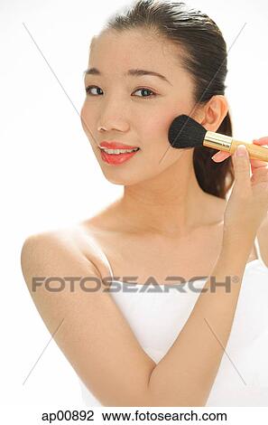 Woman applying blusher with make-up brush View Large Photo Image Stock Image - Woman applying blusher with make-up brush. Fotosearch