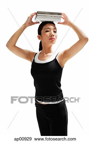 Stock Photo - Woman balancing books on her head. Fotosearch