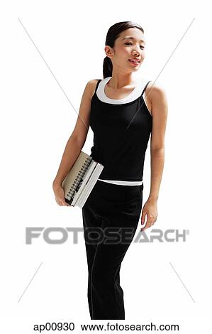 Woman carrying books, smiling, looking away View Large Photo Image Stock Image - Woman carrying books, smiling, looking away. Fotosearch