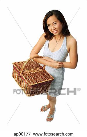 Woman carrying picnic basket, looking at camera View Large Photo Image Stock Photo - Woman carrying picnic basket, looking at camera. Fotosearch