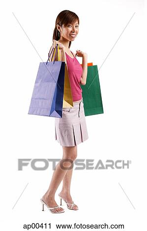 Woman carrying shopping bags View Large Photo Image Stock Image - Woman carrying shopping bags. Fotosearch
