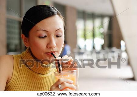 Woman drinking from straw View Large Photo Image Stock Image - Woman drinking from straw. Fotosearch