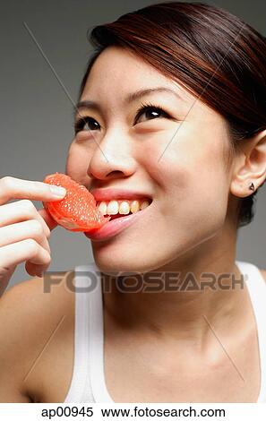 Woman eating orange slice View Large Photo Image Stock Photography - Woman eating orange slice. Fotosearch