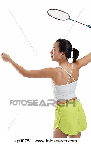 Woman holding badminton racket, about to serve View Large Photo Image Stock Image - Woman holding badminton racket, about to serve. Fotosearch