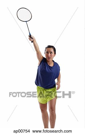 Picture - Woman holding badminton racket up. Fotosearch
