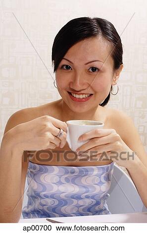 Woman holding cup, looking at camera View Large Photo Image Stock Image - Woman holding cup, looking at camera. Fotosearch