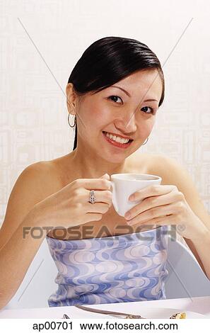 Woman holding cup, looking at camera, portrait View Large Photo Image Stock Image - Woman holding cup, looking at camera, portrait. Fotosearch