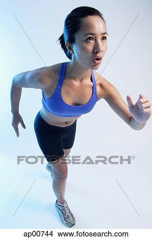 Woman in running position, high angle view View Large Photo Image Picture - Woman in running position, high angle view. Fotosearch