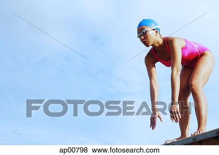Woman in swimming costume, bending over, preparing to dive View Large Photo Image Stock Photo - Woman in swimming costume, bending over, preparing to dive. Fotosearch