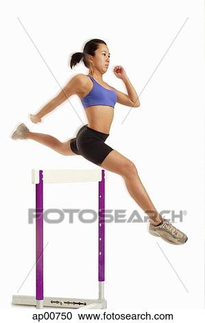 Woman jumping over hurdle View Large Photo Image Stock Image - Woman jumping over hurdle. Fotosearch
