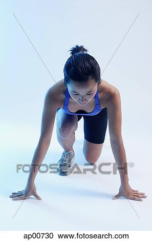 Woman kneeling at starting position View Large Photo Image Stock Image - Woman kneeling at starting position. Fotosearch