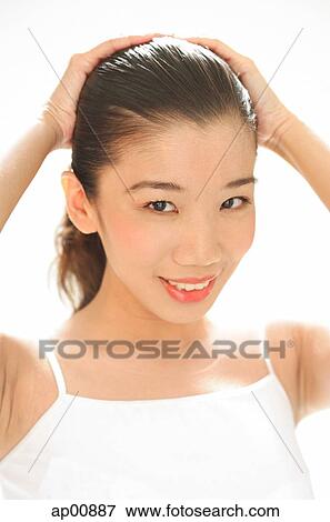 Woman looking at camera, both hands on head View Large Photo Image Stock Photo - Woman looking at camera, both hands on head. Fotosearch