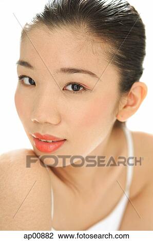 Stock Image - Woman looking at camera, head shot. Fotosearch