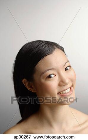 Stock Photo - Woman looking at camera, head shot. Fotosearch