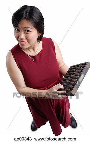 Stock Image - Woman looking at camera, holding abacus. Fotosearch