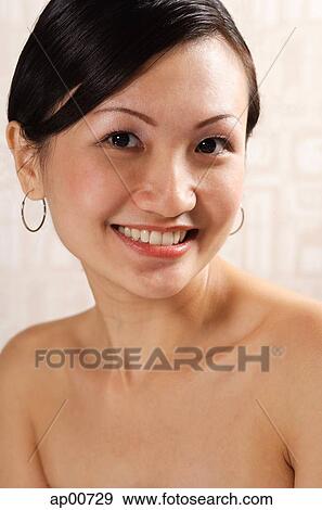 Stock Photo - Woman looking at camera, smiling, portrait. Fotosearch