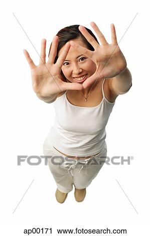 Woman looking at camera, through her hands View Large Photo Image Stock Image - Woman looking at camera, through her hands. Fotosearch