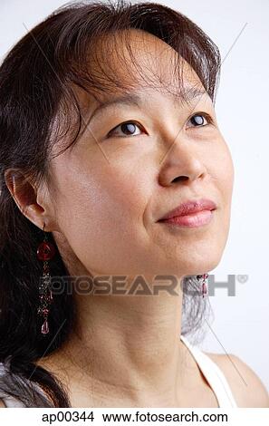 Woman looking away, head shot View Large Photo Image Picture - Woman looking away, head shot. Fotosearch