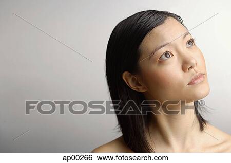 Stock Photograph - Woman looking away, head shot. Fotosearch