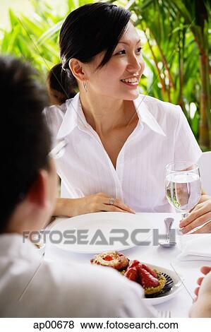 Stock Photo - Woman looking away, man in front of her, over the shoulder view. Fotosearch