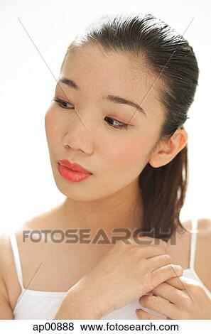 Woman looking away, touching hair View Large Photo Image Stock Photo - Woman looking away, touching hair. Fotosearch