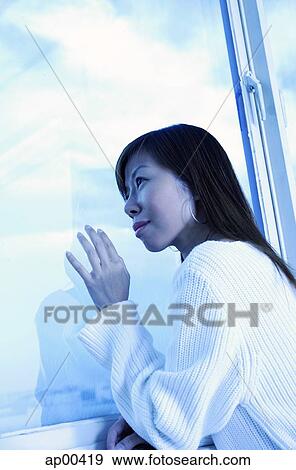 Woman looking through window View Large Photo Image Stock Photo - Woman looking through window. Fotosearch