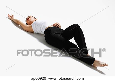 Woman lying on back, stretching View Large Photo Image Stock Image - Woman lying on back, stretching. Fotosearch
