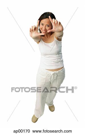 Woman making hand sign, looking at camera View Large Photo Image Stock Image - Woman making hand sign, looking at camera. Fotosearch