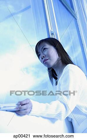 Woman next to window, looking away View Large Photo Image Stock Image - Woman next to window, looking away. Fotosearch