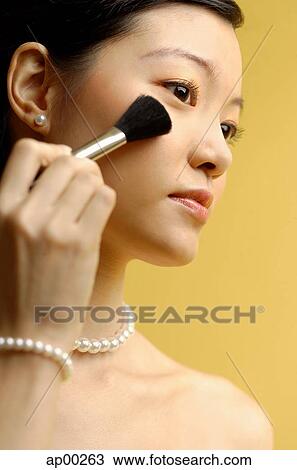 Woman putting on blusher with make up brush View Large Photo Image Stock Image - Woman putting on blusher with make up brush. Fotosearch