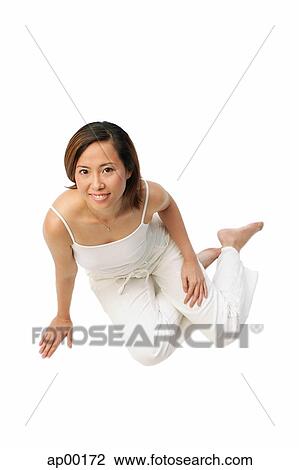 Woman sitting on floor, looking up at camera View Large Photo Image Stock Image - Woman sitting on floor, looking up at camera. Fotosearch