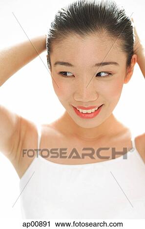 Woman smiling, hands on head, looking away View Large Photo Image Stock Image - Woman smiling, hands on head, looking away. Fotosearch