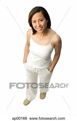 Stock Photograph - Woman smiling up at camera, studio shot. Fotosearch