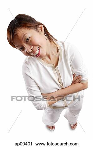 Stock Image - Woman standing, arms crossed, looking at camera. Fotosearch
