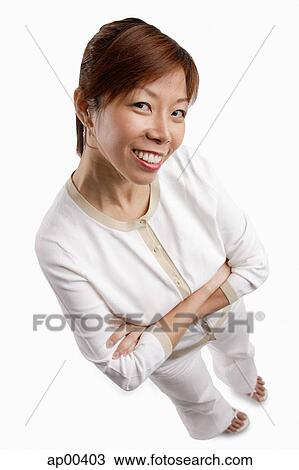 Woman standing, arms crossed, looking at camera View Large Photo Image Stock Image - Woman standing, arms crossed, looking at camera. Fotosearch