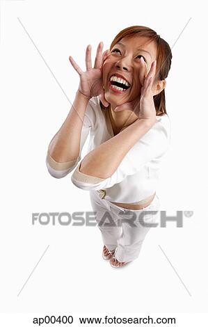 Woman standing, hands on face, shouting View Large Photo Image Stock Image - Woman standing, hands on face, shouting. Fotosearch
