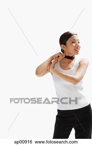 Woman standing, pulling ponytail around her neck View Large Photo Image Stock Photograph - Woman standing, pulling ponytail around her neck. Fotosearch