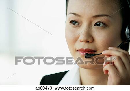 Woman wearing headset, looking away View Large Photo Image Stock Photo - Woman wearing headset, looking away. Fotosearch