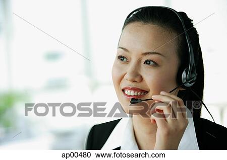 Woman wearing headset, smiling View Large Photo Image Stock Image - Woman wearing headset, smiling. Fotosearch
