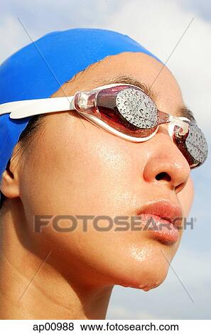 Woman wearing swimming goggles, head shot View Large Photo Image Stock Photo - Woman wearing swimming goggles, head shot. Fotosearch
