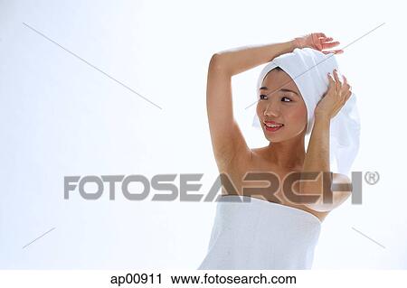 Stock Image - Woman wearing towel on head. Fotosearch