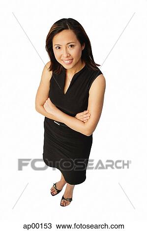 Woman with arms crossed, looking up at camera View Large Photo Image Stock Image - Woman with arms crossed, looking up at camera. Fotosearch